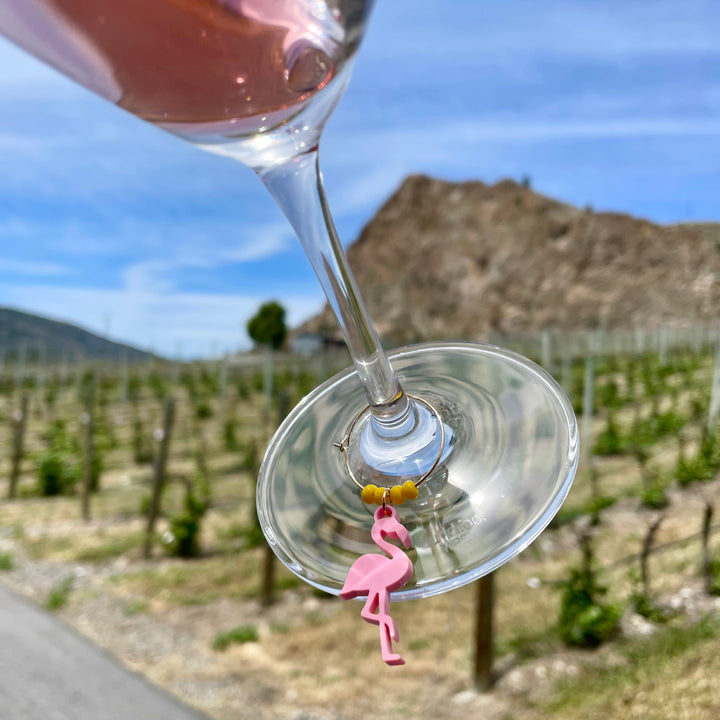 One yellow Flamingo Wine charm on a glass