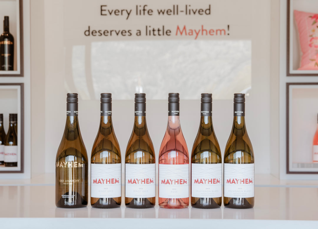 6 bottles of Mayhem Wines lined up on the counter in the Tasting Room